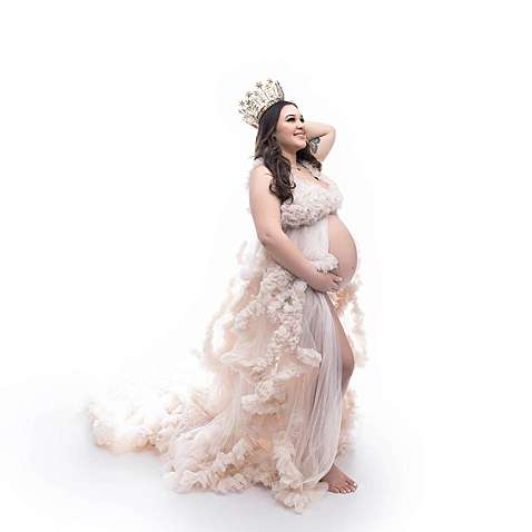Gorgeous backlit maternity photo of a mom in a studio on the shoreline of connecticut.
