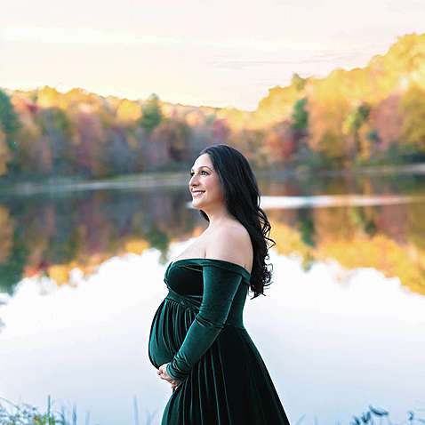Pregnancy photos at a lake during fall foliage season in Connecticut.